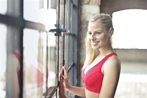 Smiling Woman In Red Brassiere Near Glass Window Picture Image 109930496