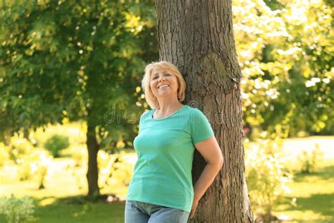portrait of beautiful mature woman in green park stock image image of people lifestyle 151134373