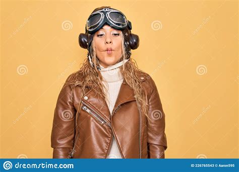 Young Beautiful Blonde Aviator Woman Wearing Vintage Pilot Helmet Whit Glasses And Jacket Making