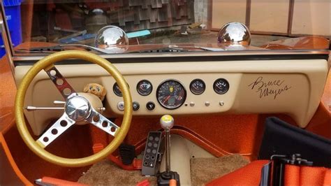 The Interior Of An Old Car With Steering Wheel And Gauges
