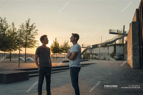 Two Friends Meeting At Sunset Spending The Evening Talking — Copy