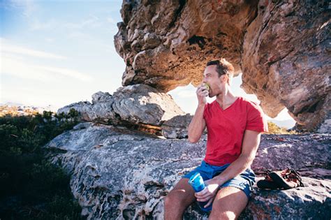 Use them in commercial designs under lifetime, perpetual & worldwide rights. Climber Man Eating Apple During Rest From Extreme Rock Climbing Stock Photo - Download Image Now ...