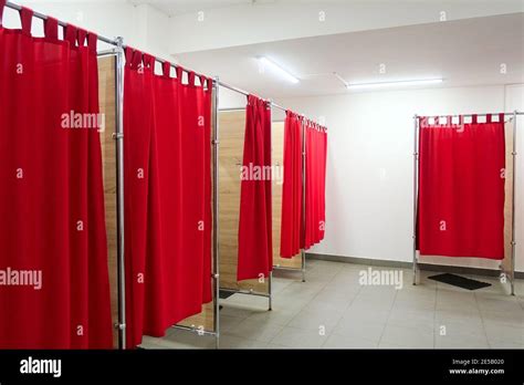 Empty Fitting Rooms With Red Curtains And White Walls Dressing Rooms In Clothing Store With No