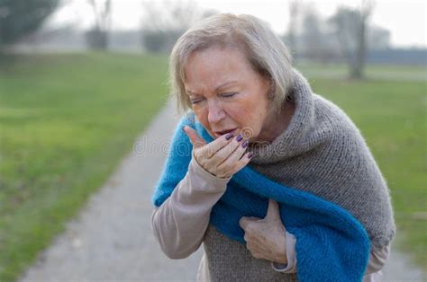 Elegant Senior Woman Coughing Into Her Hand Stock Photo Image Of Lady