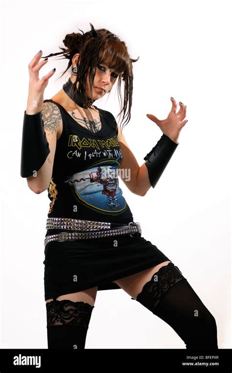 Pretty Young Heavy Metal Female Punk With Horns Piercings And Tattoos