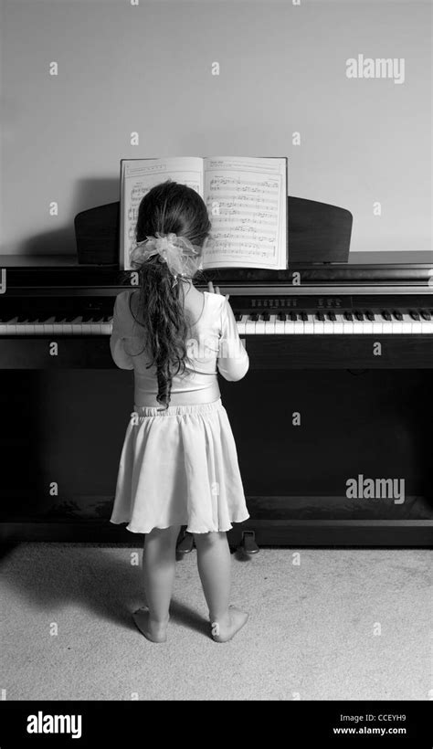 Little Girl Playing Piano Rear Black And White Stock Photos And Images