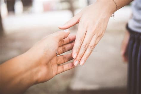 Two People Holding Hands For Comfort Giving A Helping Hand Stock Photo
