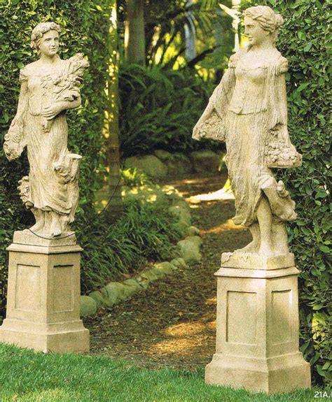 Two Statues In The Middle Of A Garden