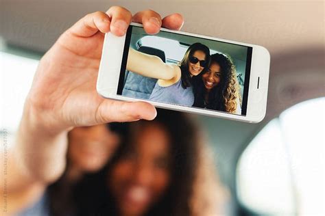 Happy Multiethnic Female Friends Taking A Selfie Inside A Car By Stocksy Contributor