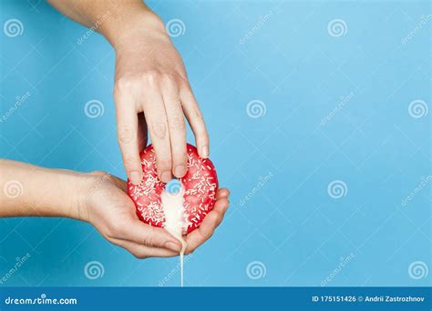 Female Hands And A Donut On A Blue Background As A Symbol Of Masturbation And Foreplay Prelude