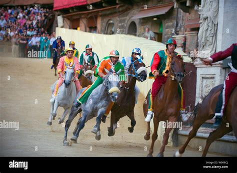 Riders Racing At El Palio Horse Race Festival Piazza Del Campo Siena