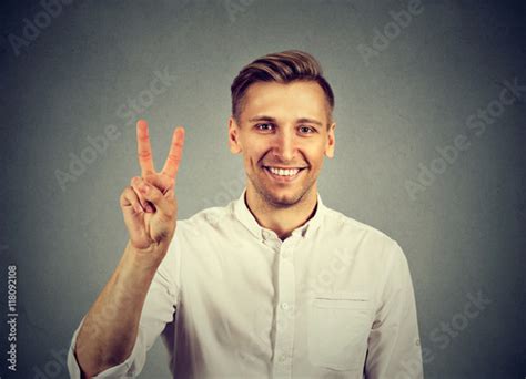Young Handsome Man Holding Up Peace Victory Two Sign Buy This Stock