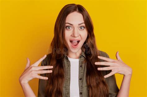 Portrait Of Funny Positive Girlish Lady Hold Palms Open Mouth On Yellow