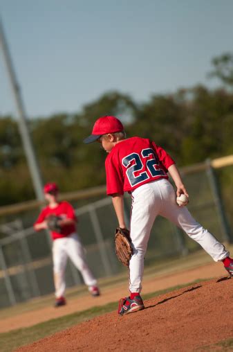 Little League Baseball Pitcher Looking At Batter Stock Photo Download