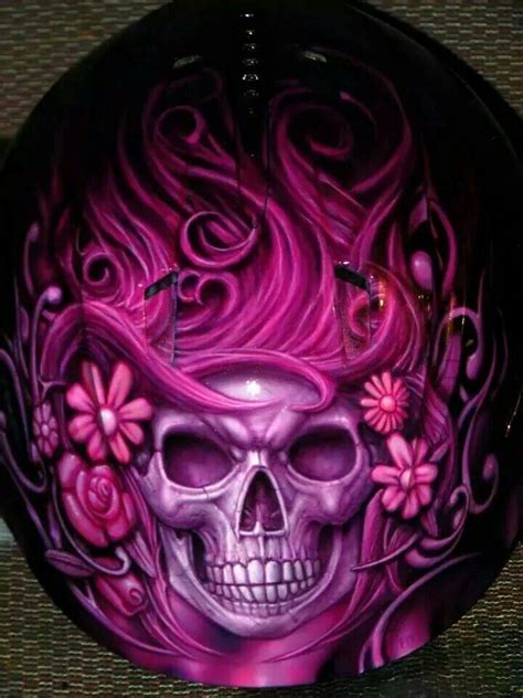 A Purple Skull With Flowers Painted On It