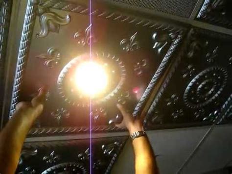 Square ceiling tiles offer a traditional look in the office when paired with matching lighting panels. How to Intall Ceiling Tile Around Light Fixture grid - YouTube