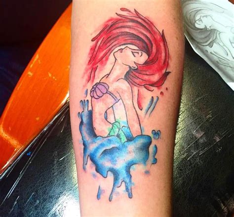 This tattoo features a mermaid on the arm that has been executed to perfection. Ariel Disney tattoo | Mermaid tattoos, Mermaid sleeve ...