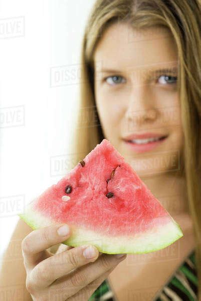Woman Offering Slice Of Watermelon Stock Photo Dissolve