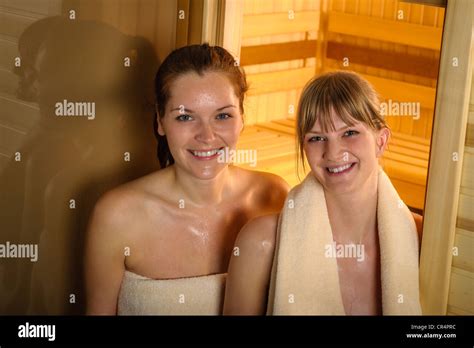 Happy two women sweating at sauna at spa center Stock Photo - Alamy