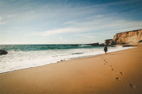 lone woman enjoys walk on the beach in idyllic paradise view woman in beach paradise 4k hd