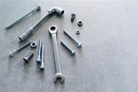 Construction Tools The Screws Nuts And Bolts On Concrete Background