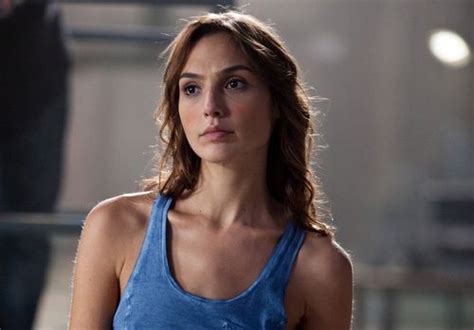 A Woman Wearing A Blue Tank Top Looking At The Camera With An Intense Look On Her Face