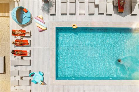 Drone View Of People Who Relaxing In A Swimming Pool From Stock Photo