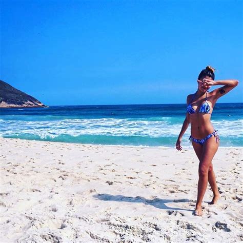 EGO Carolina Oliveira posa de biquíni na praia em dia de folga