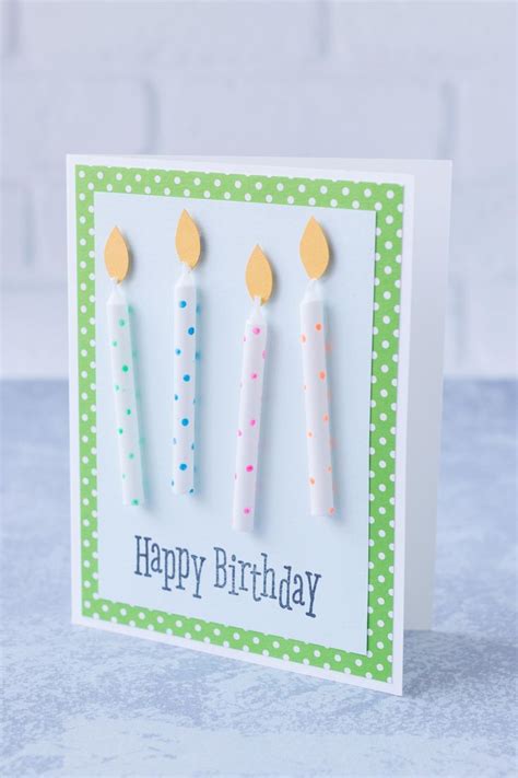 Three Birthday Candles On A White Card With Green Polka Dot Paper And