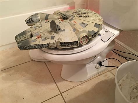A Star Wars Model Sits On Top Of A Toilet