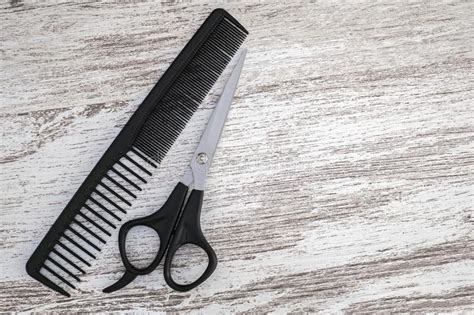 Hair Cutting Scissor For Hairdressers And Black Comb Stock Image