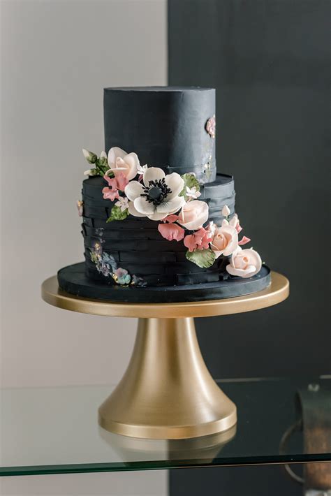 unique dark luxe black two tier wedding cake with cascading white anemone and blush pink flowers