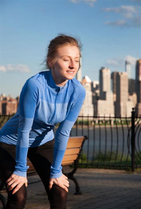 Woman Runner Taking A Rest After Run Sitting On The Running Stock Image