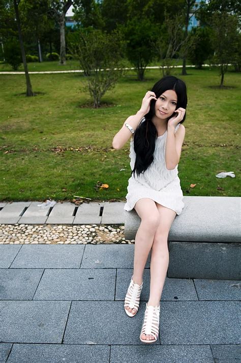 Free Photos A Beautiful Chinese Girl Posing On A Bench Outdoors