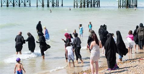 Burkini Ban Women In Burkas Paddle At Brighton Beach After French