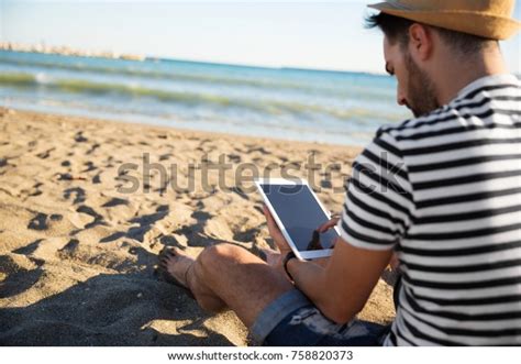 Man Sitting On Beach Reading Ebook Stock Photo Edit Now