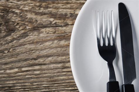 A female or a portion thereof that is so delectable that to properly indulge, one would require the use of a fork and knife. knife and fork on a plate ~ Food & Drink Photos on Creative Market