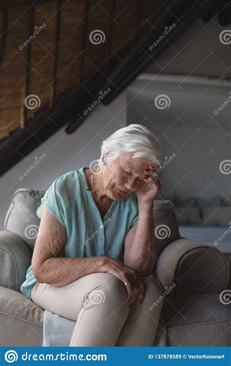 worried senior woman sitting in living room stock image image of authentic headache 137878589