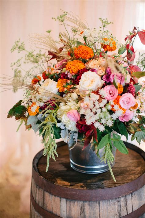 Colorful Fall Flower Arrangements On Barrels