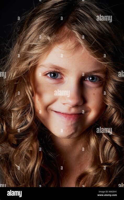 Kinky Girl With Long Hair In The Studio On A Black Background A Fairy