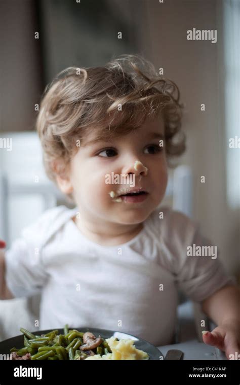 Toddler Boy With Food On His Face Portrait Stock Photo Alamy