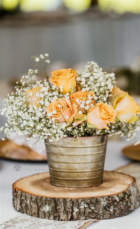 Simple Rustic Peach White Babys Breath And Rose Centerpiece On Wood