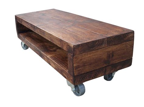 This coffee table pairs the industrial with the rustic to create a distinctive design. industrial style low tv stand with cast iron wheels | Tv ...