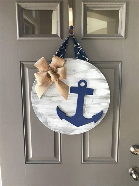 A Door Hanger With An Anchor And Bow Hanging On Its Front Door