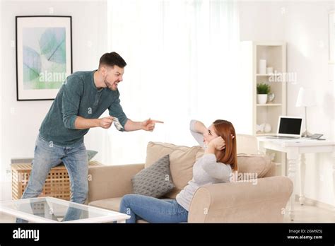 Angry Man Scolding His Wife For Overspending At Home Stock Photo Alamy