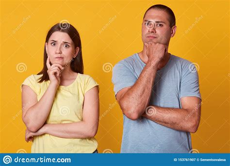 Thoughtful Beautiful Couple Looking Directly At Camera Posing Isolated