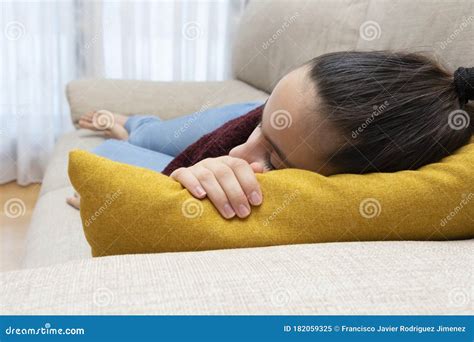 Girl Sleeping In A Relaxed Position On A Sofa With Coloured Pillow Stock Image Image Of Alone