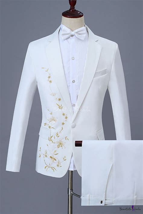 A White Tuxedo Suit With Gold Embroidered Details