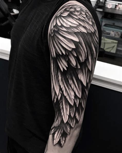 Done in black ink, the detailed wing is intricate, realistic, and bold. Angel Wings Tattoo Design