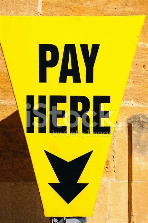 Yellow Pay Here Sign Stock Photo Royalty Free Freeimages